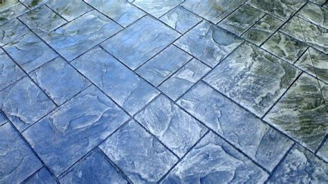 A close up of a blue tiled floor with a pattern