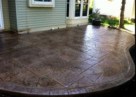 A concrete patio in front of a house with a window