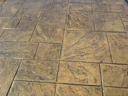 A close up of a concrete floor with square tiles
