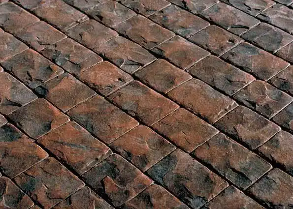 A close up of a brick floor with a diagonal pattern