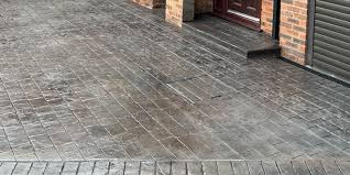 A close up of a brick driveway in front of a brick building