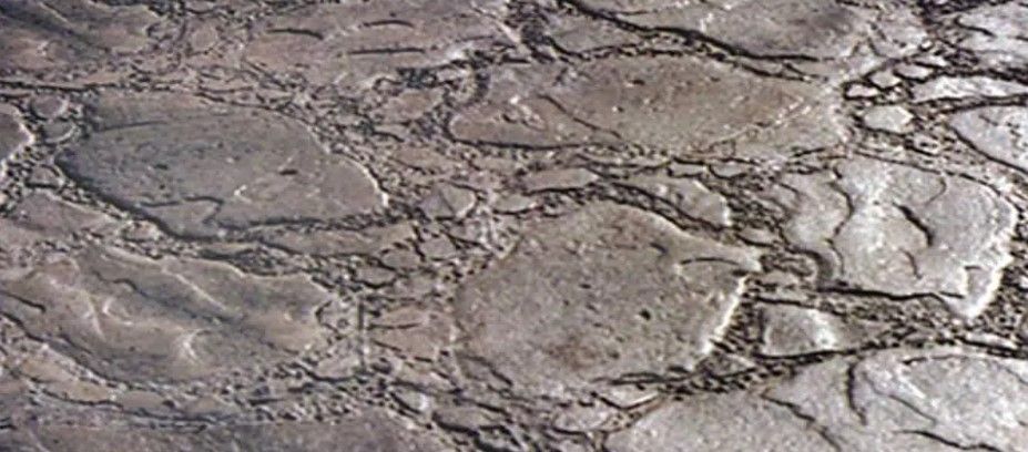 A close up of a metal surface with a marble texture