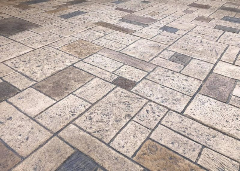 A close up of a brick floor with a geometric pattern