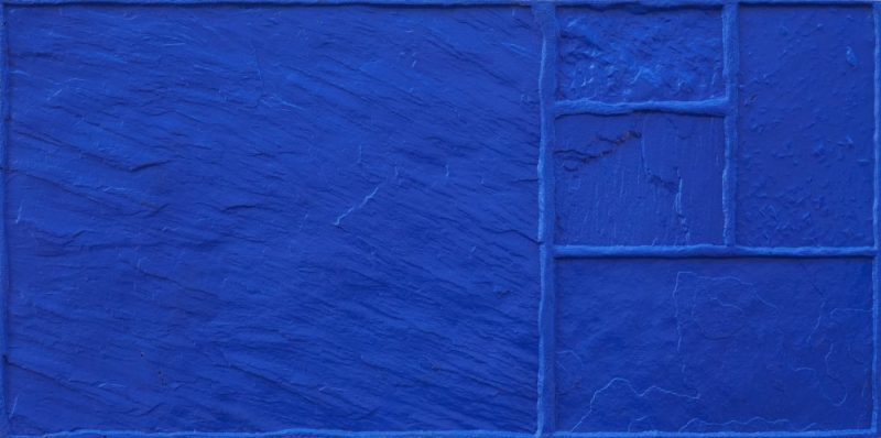 A close up of a blue tile with a geometric pattern on it