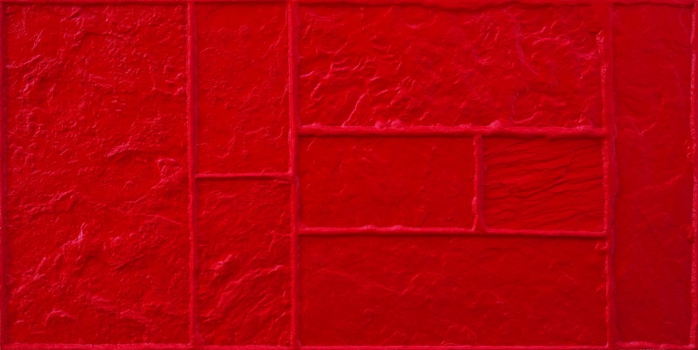 A close up of a red tile pattern on a wall