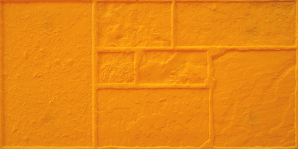 A close up of a yellow wall with squares on it