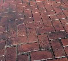 A close up of a brick floor with a herringbone pattern