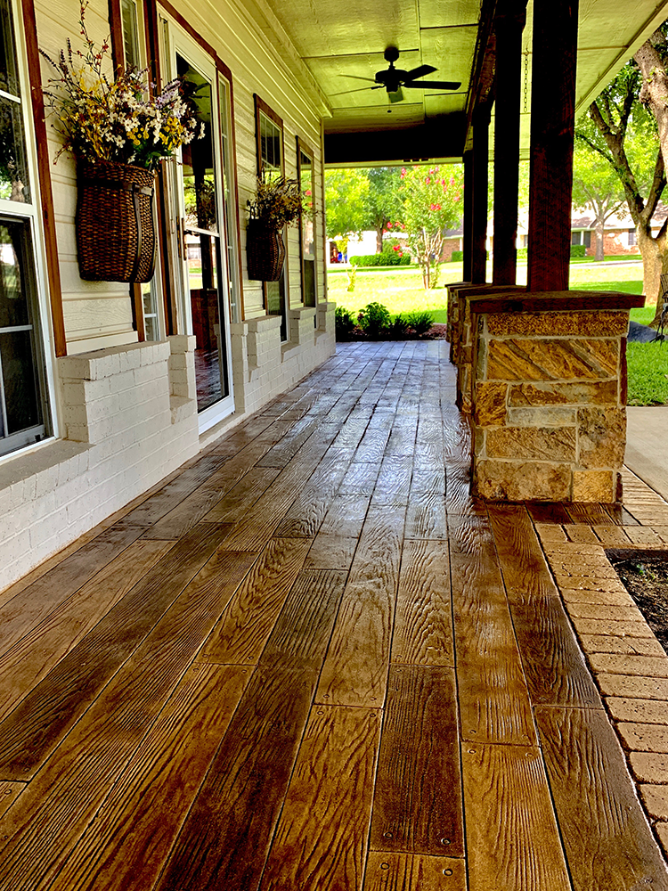 A porch with a wooden floor and a ceiling fan