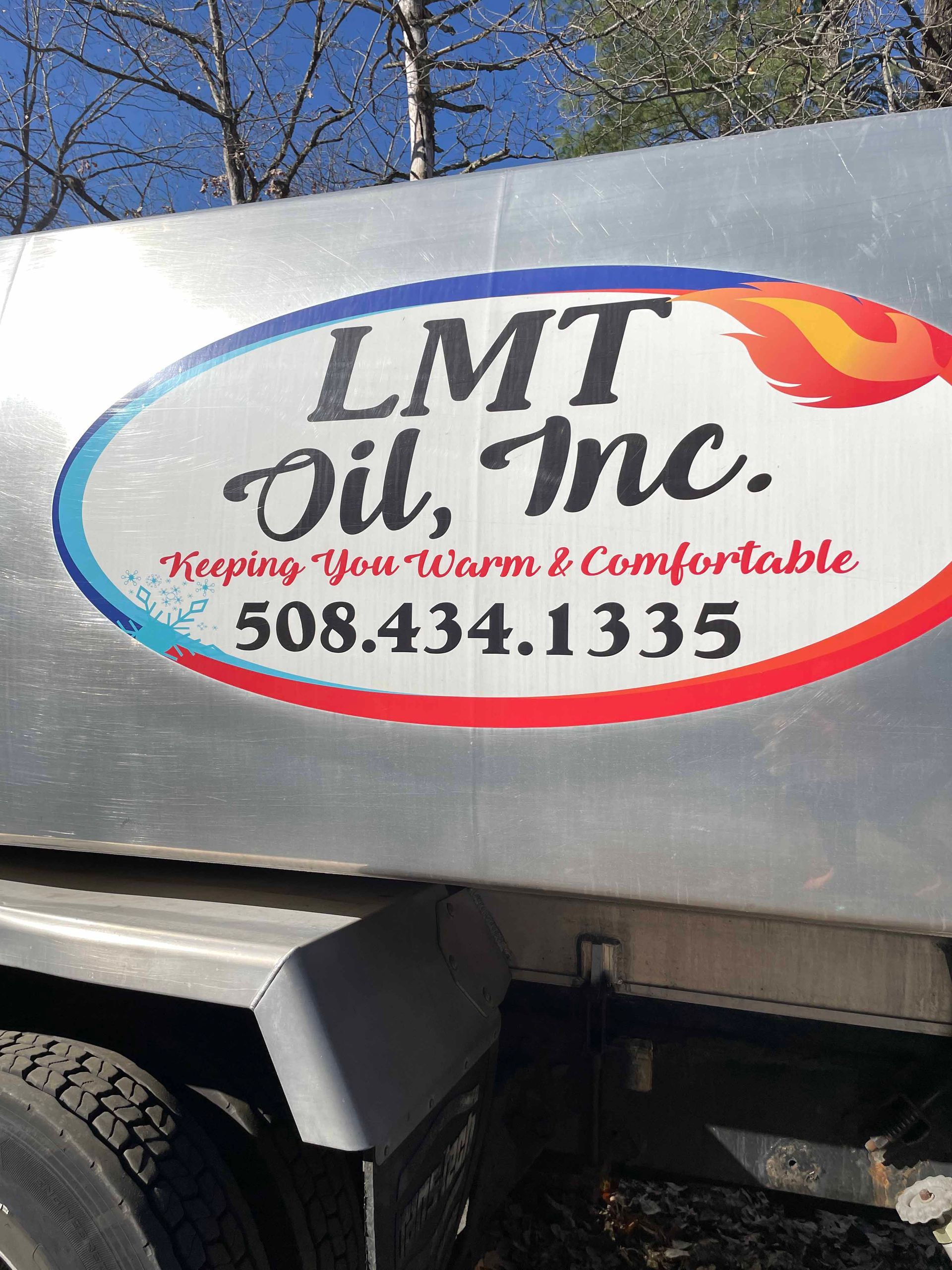 A sign on the side of a truck says lmt oil inc.