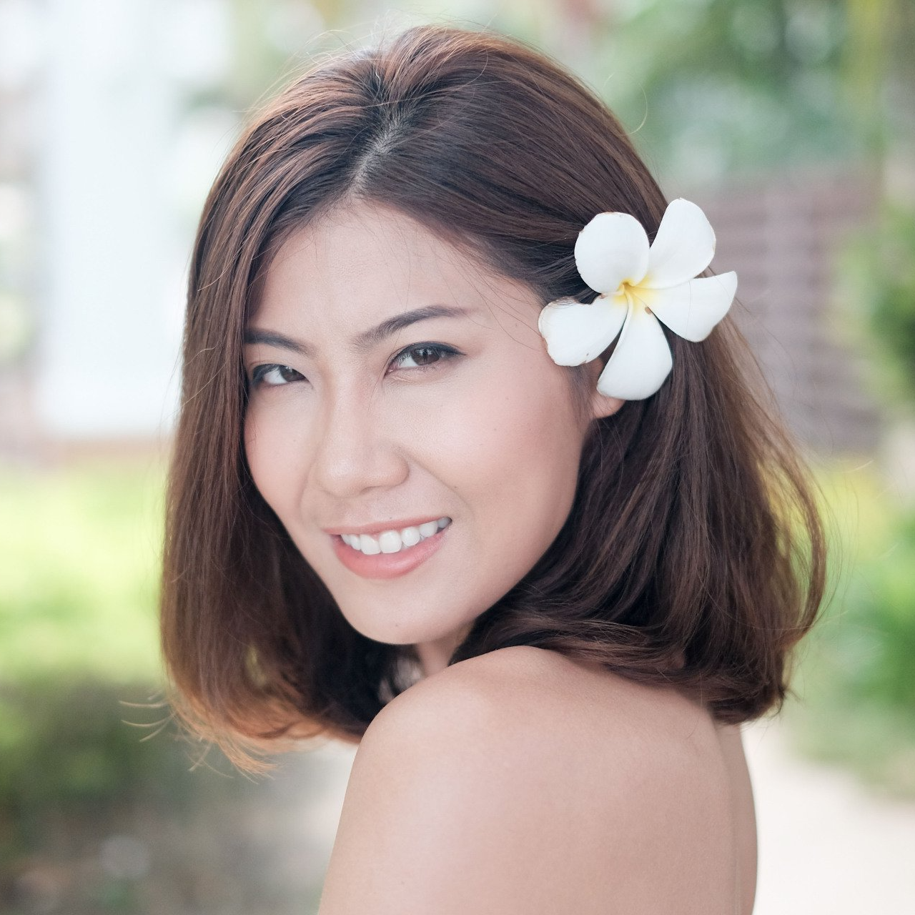 A woman with a white flower in her hair