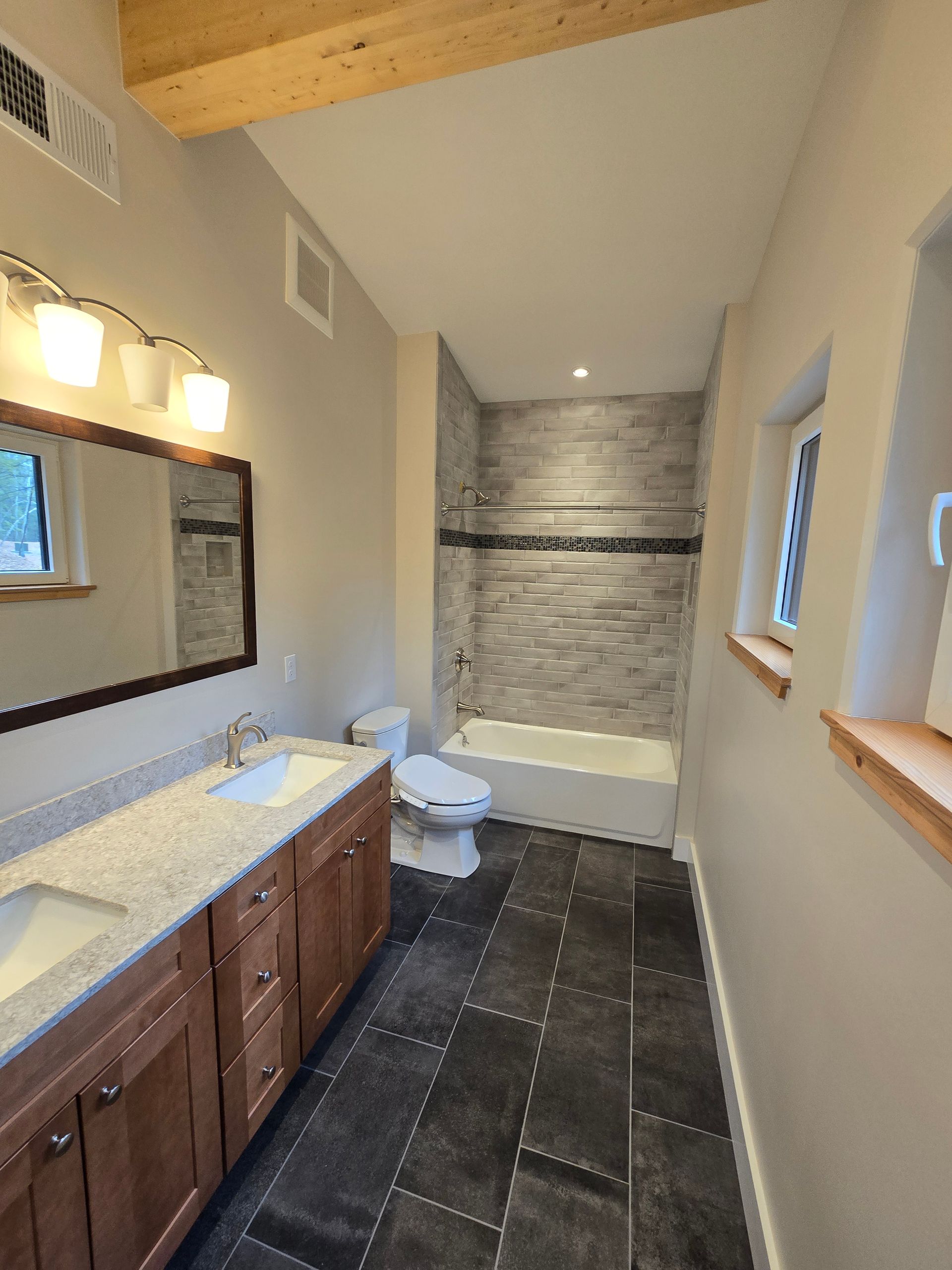 A bathroom with a toilet , sink and bathtub
