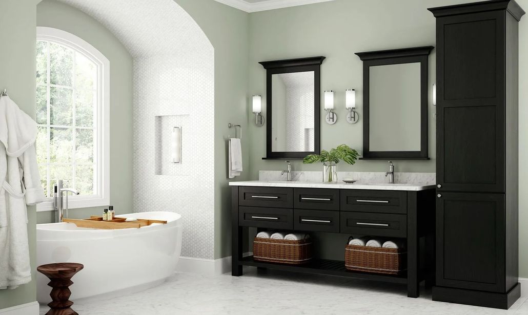 Bathroom with a white tub, black double vanity, and tall black cabinet; green walls, large window.