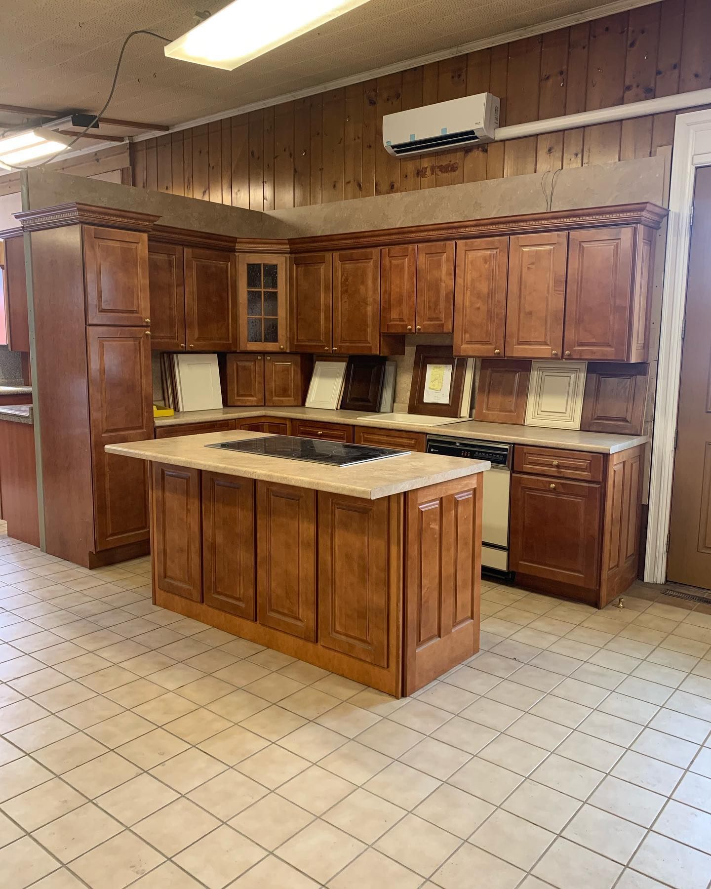 Wooden kitchen cabinets and island in a showroom.