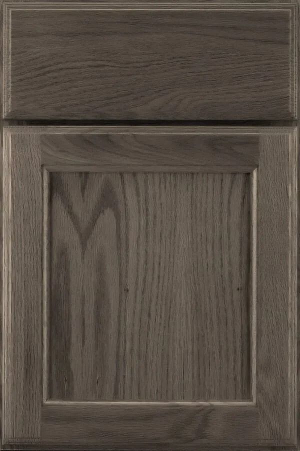 Gray-stained, raised-panel cabinet door with wood grain texture.
