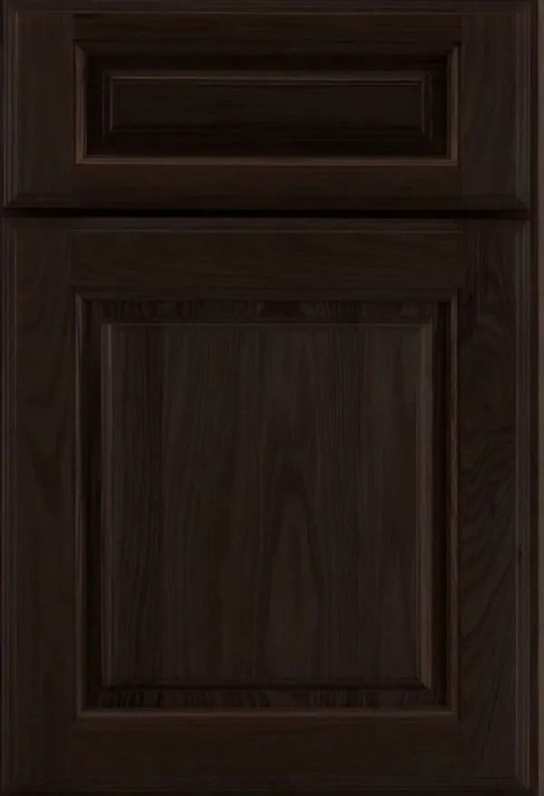 Dark brown, raised panel cabinet door with recessed upper panel.