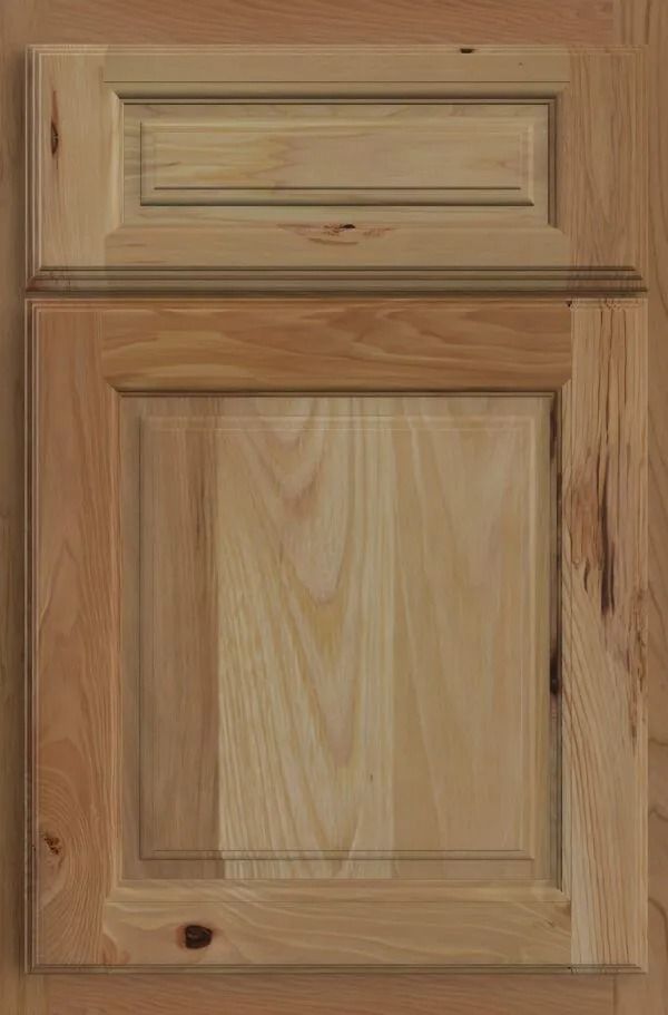 Wooden cabinet door with raised panel and trim detail. Light brown wood grain.