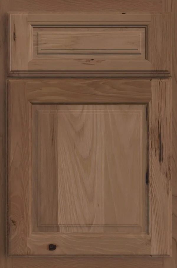 Wooden cabinet door with raised panel design, stained a light brown color.
