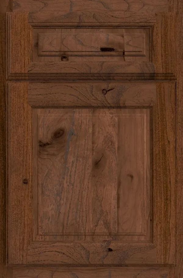 Close-up of a dark brown wooden cabinet door with a raised panel design, showing wood grain and texture.