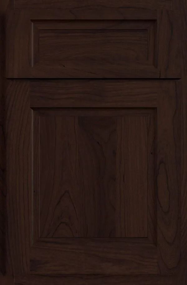 Dark brown wooden cabinet door with recessed paneling.
