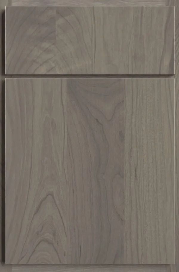 Gray-stained wood cabinet door with a raised panel, showing the wood grain.