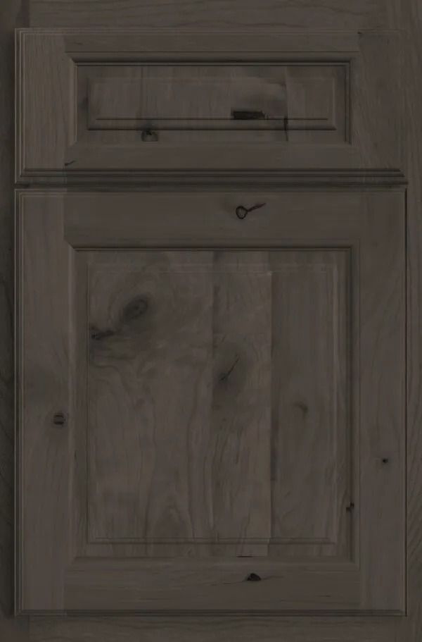 Dark stained wooden cabinet door with raised panel and upper detail.