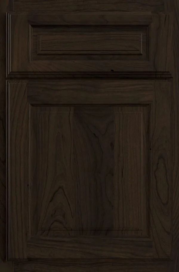 Dark brown wood cabinet door with raised paneling.