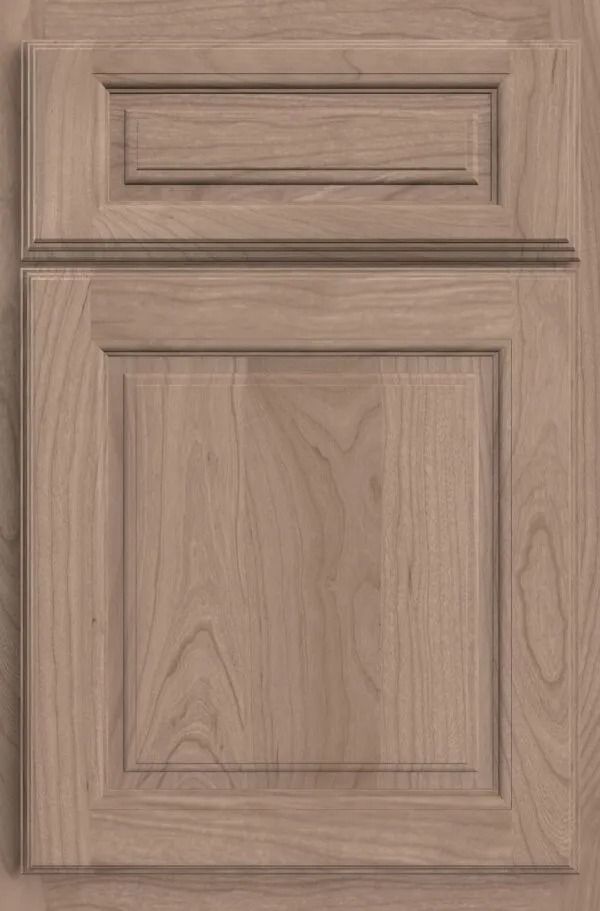 Light brown kitchen cabinet door with raised panel and top detail.