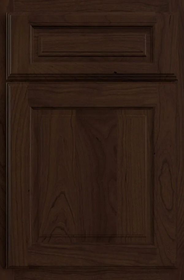 Dark brown wooden cabinet door with raised paneling.