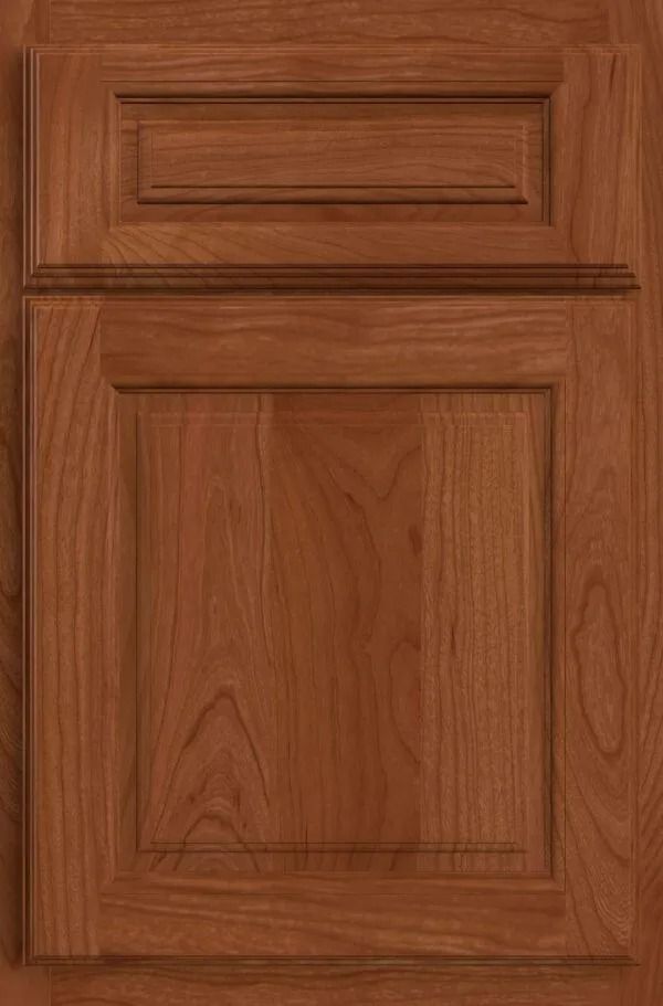 Cherry wood cabinet door with raised panel and top rectangular detail.