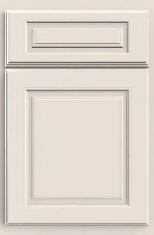 Cream-colored cabinet door with raised panel design, two-part construction, and ornate detailing.