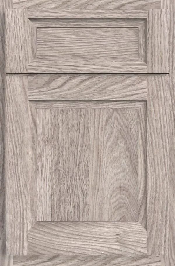 Light gray wood cabinet door with raised panel and recessed upper panel.
