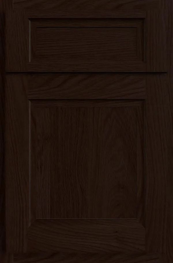 Dark brown wooden cabinet door with recessed paneling.