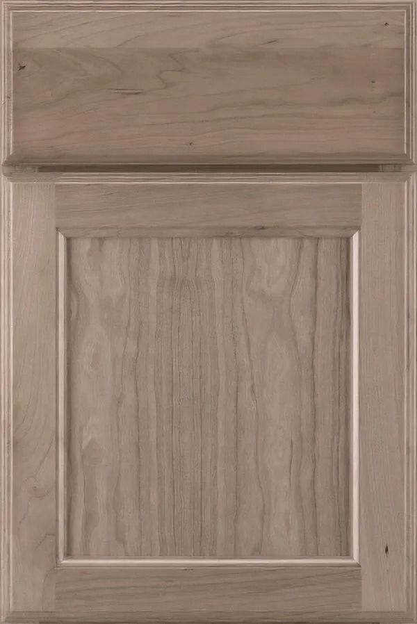 Light brown wooden cabinet door with raised panel and top rail.