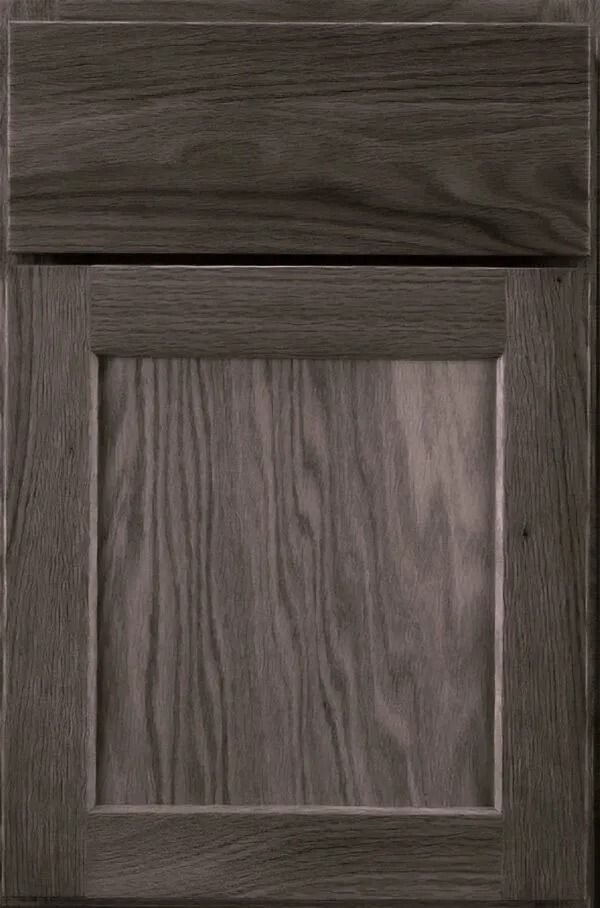 Dark stained wooden cabinet door with raised panel.