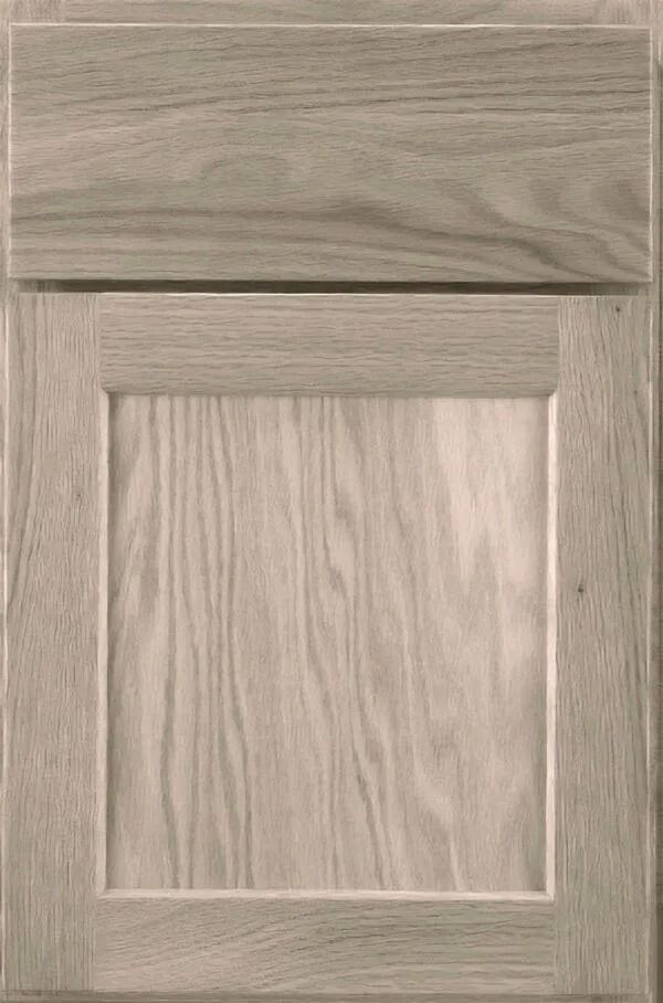 Wooden cabinet door with a raised panel design, in a light, natural wood tone.