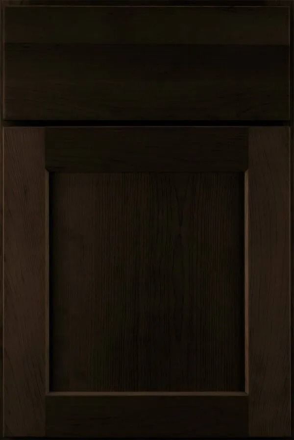 Dark brown cabinet door with a raised panel.