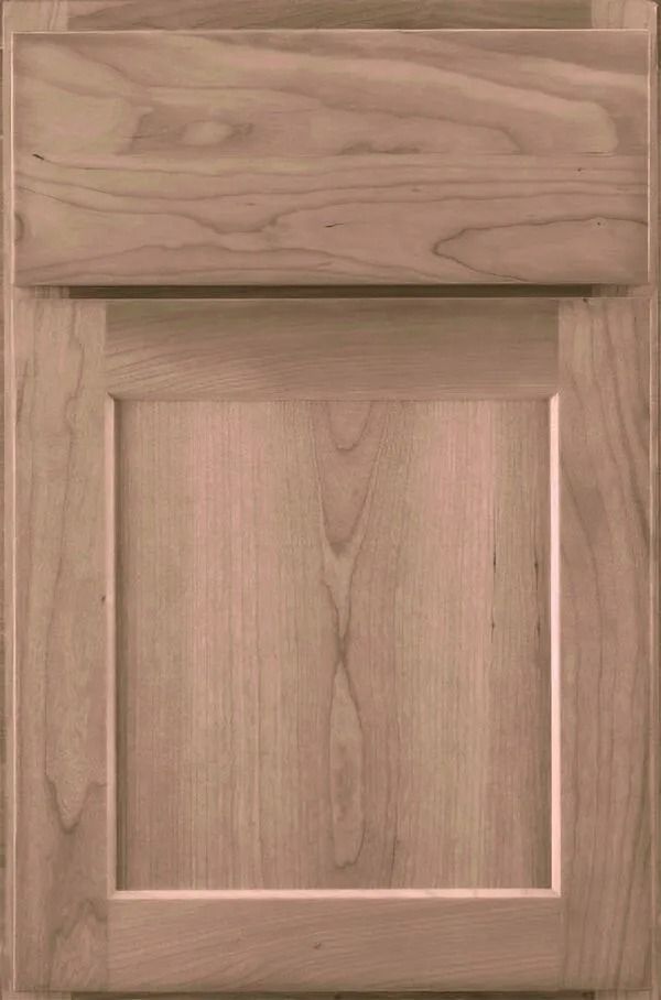 Light-colored wooden cabinet door with raised panel and upper drawer.