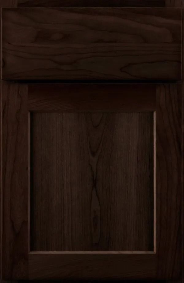 Dark brown kitchen cabinet with recessed panel and a raised top section.