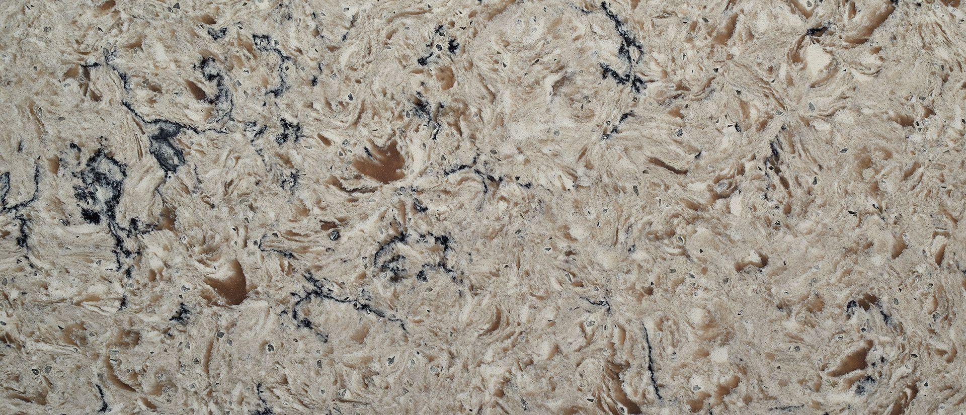 Close-up of a speckled beige and gray stone surface.