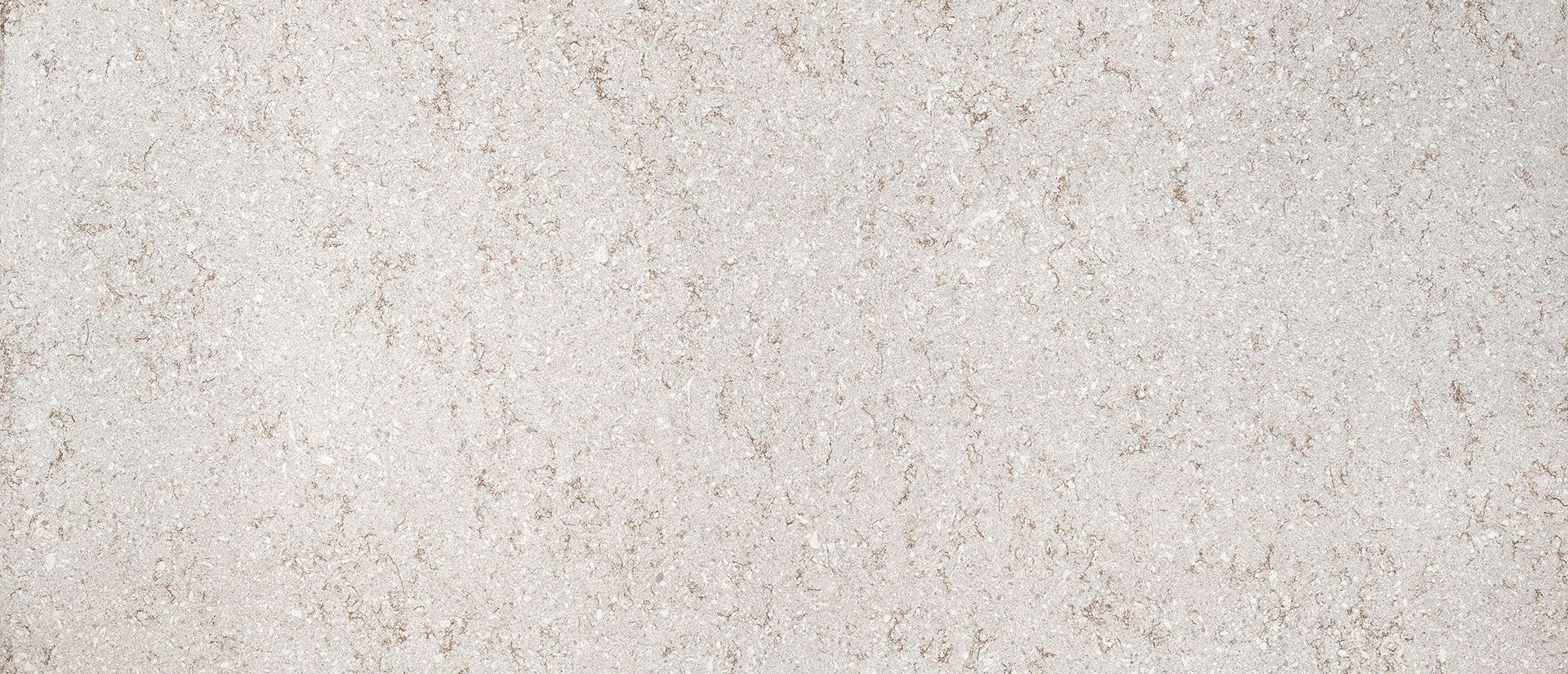 Off-white textured background with small dark flecks.