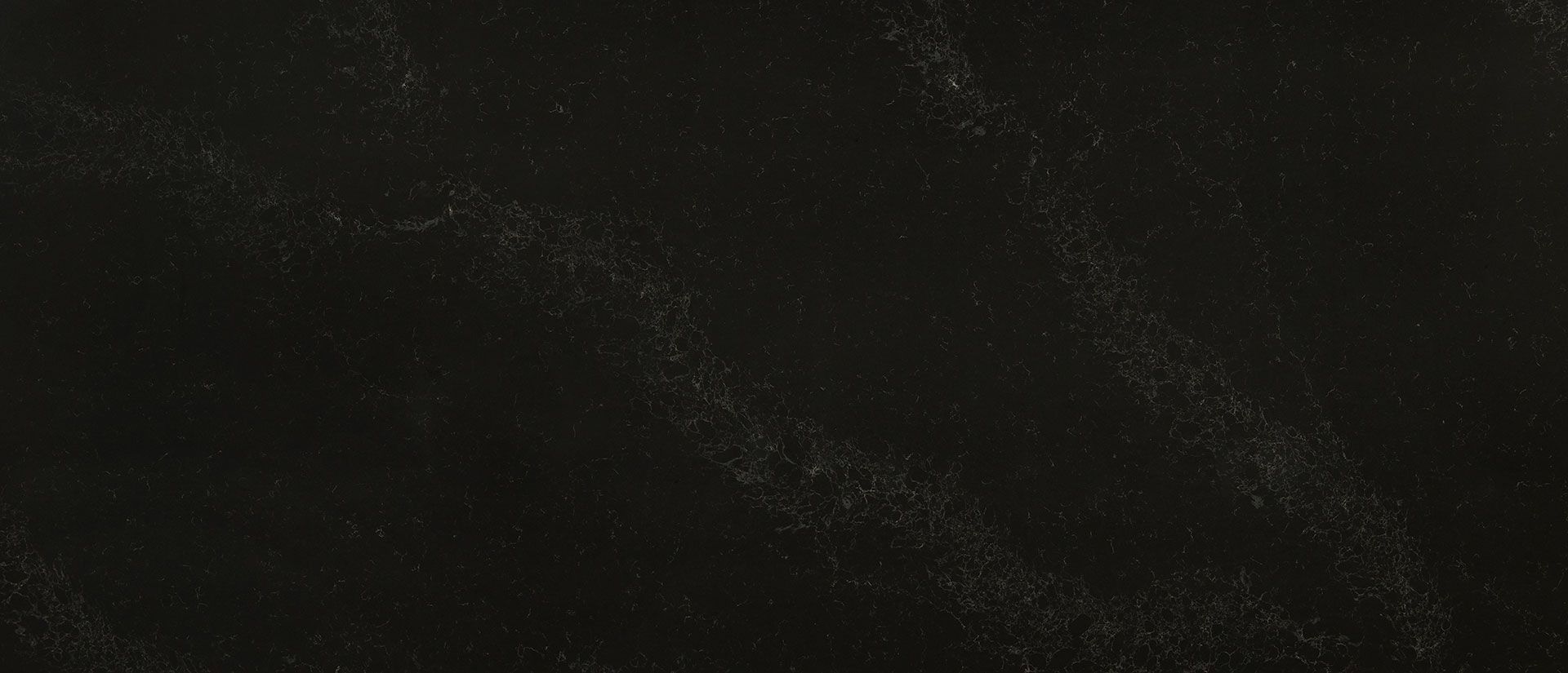 Black surface with white speckled streaks.