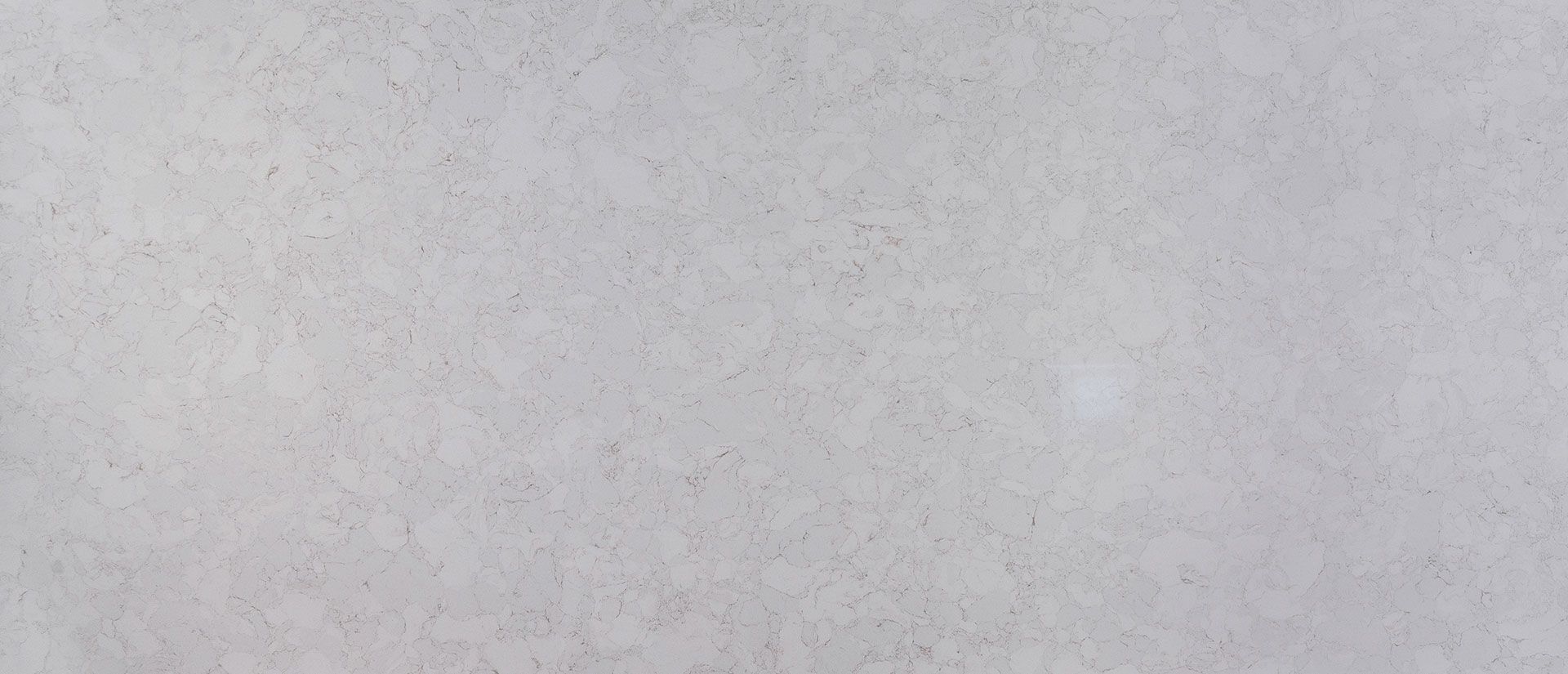 Light gray, textured background with subtle tonal variations.