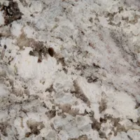 Close-up of granite countertop with white, gray, and brown veining and speckled patterns.