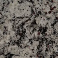 Close-up of granite countertop. Gray and white background with black and maroon flecks.