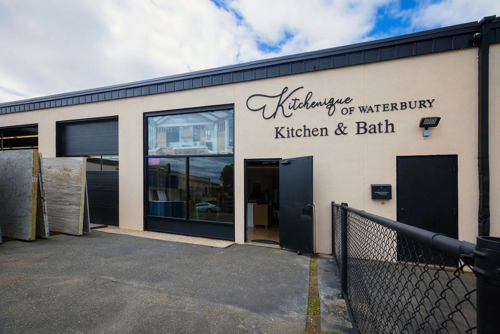 Exterior of Kitchens of Waterbury building with open door and window.