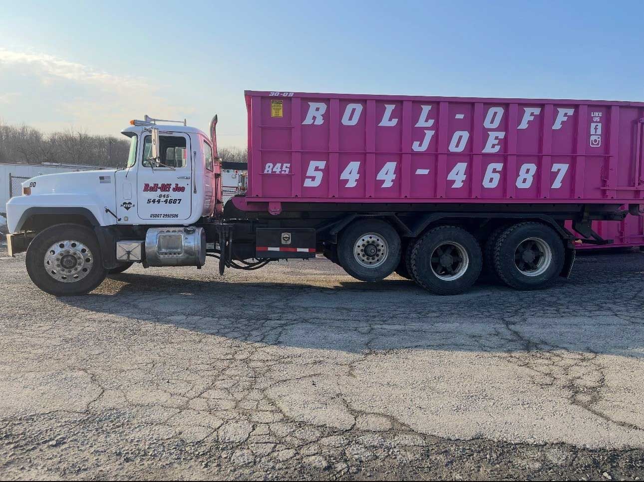 White Mack truck with pink dumpster for 