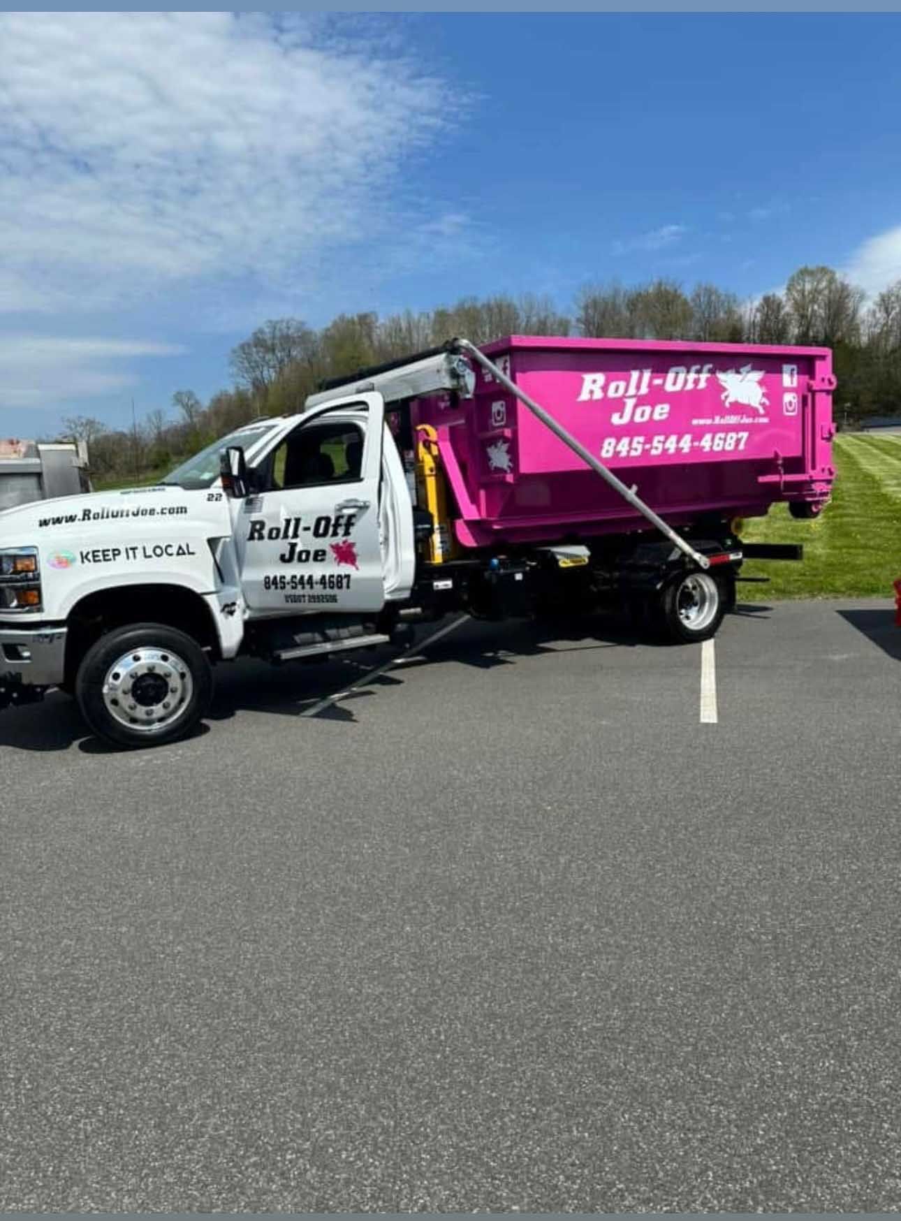 White truck with pink dumpster, 