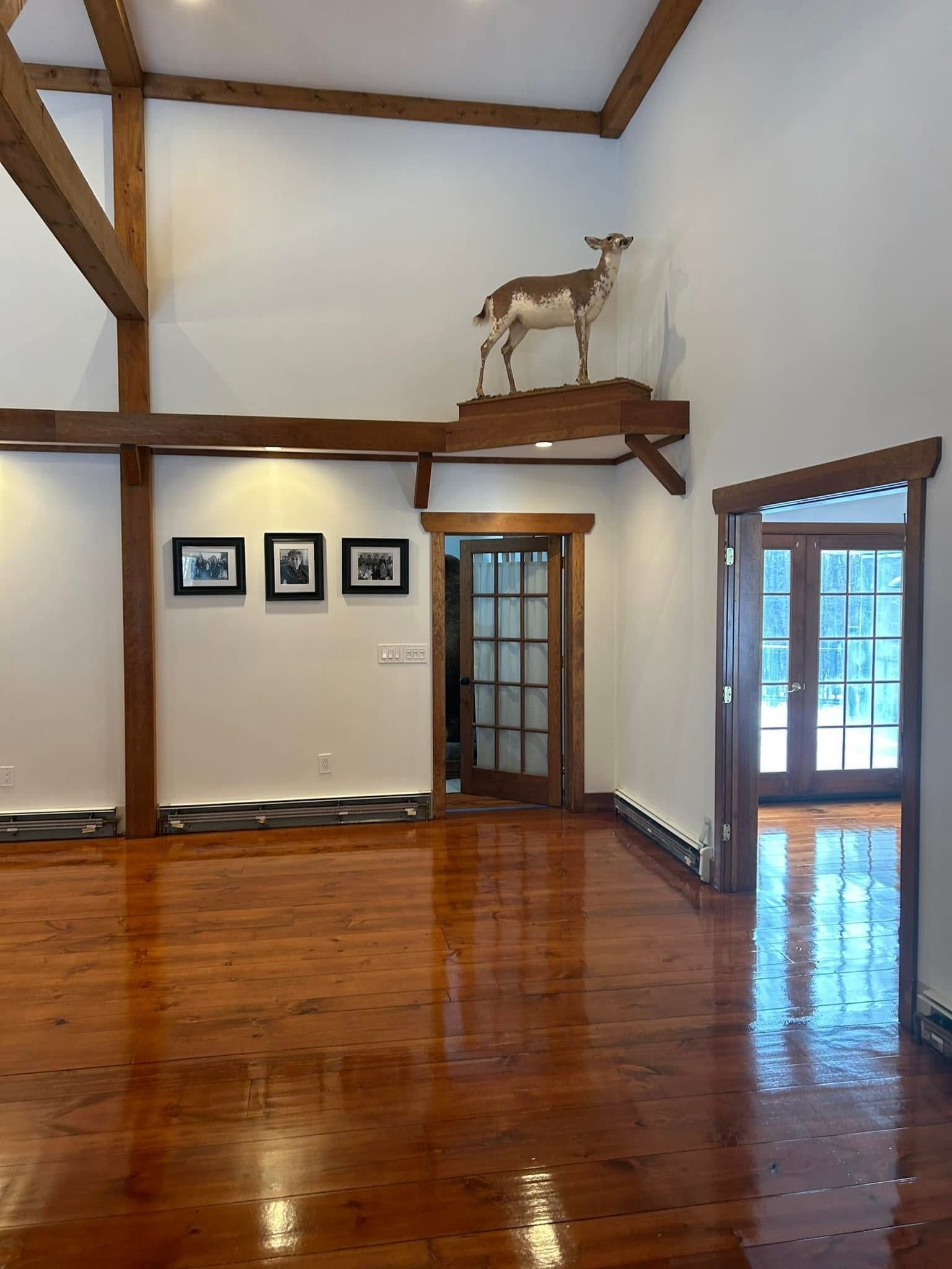 An empty room with a deer statue.