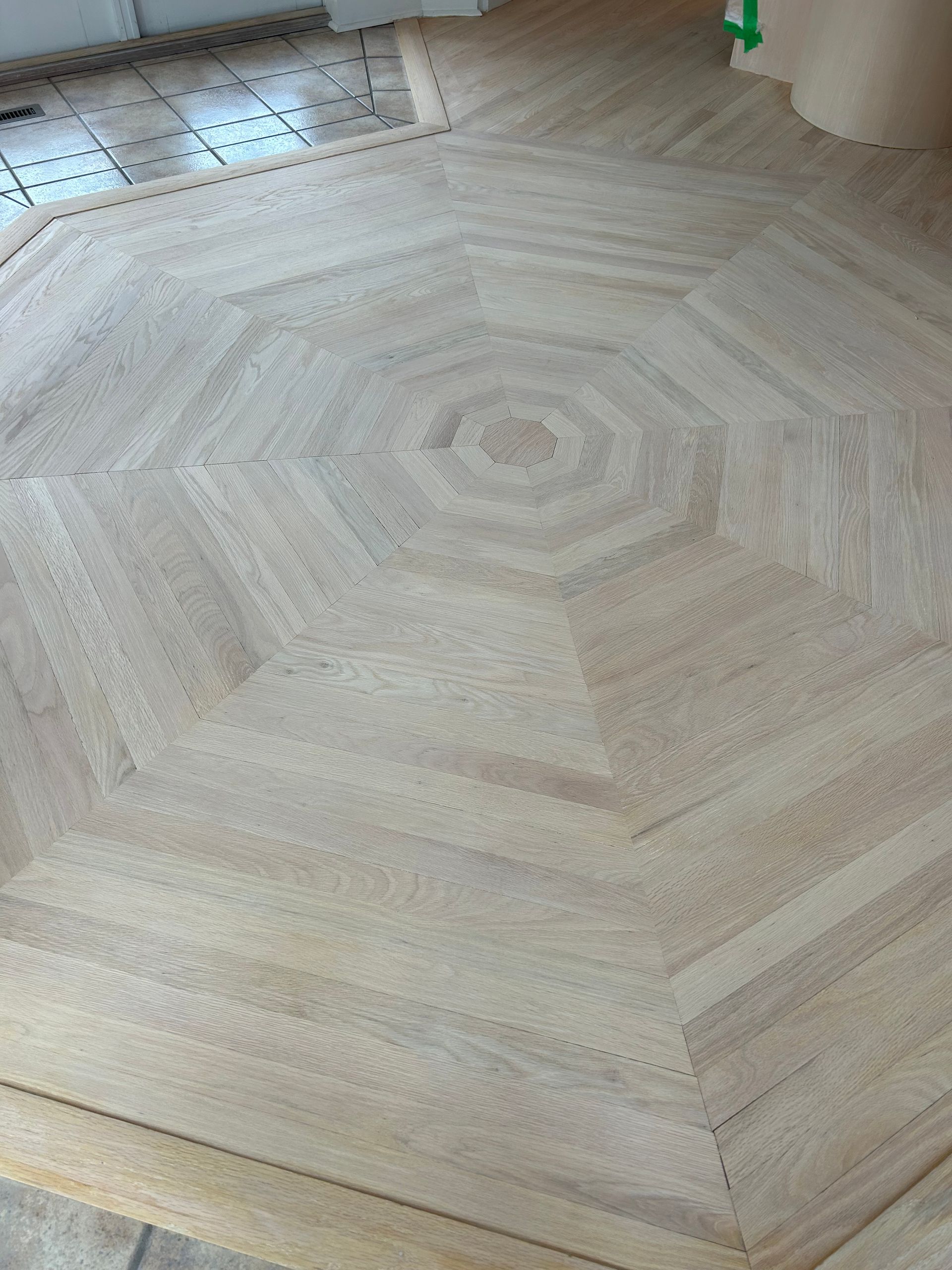 A wooden floor with a circular pattern on it.