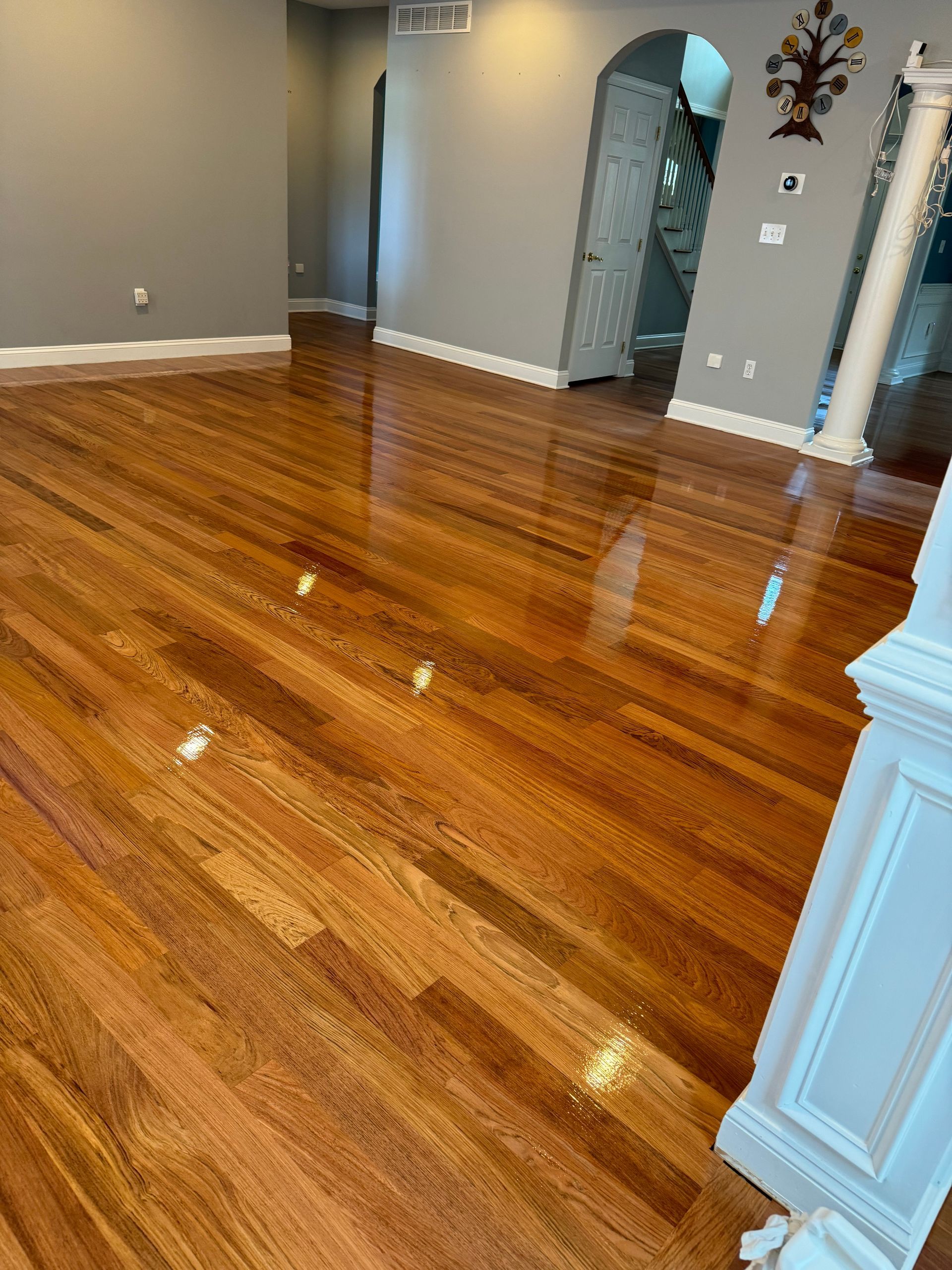 A living room with hardwood floors and a fireplace.
